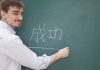 Ein Mann schreibt die chinesische Sprache auf eine Tafel. ein Beispiel für Hard Skills