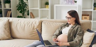 Eine Schwangere informiert sich über das Mutterschutzgesetz
