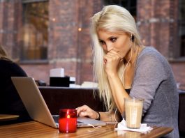 Eine Frau arbeitet in einem Cafe, ein Beispiel für Remote Work
