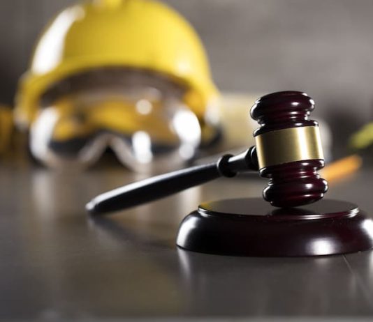 Ein Richterhammer und ein Bauhelm, Symbolbild für verdeckte Arbeitnehmerüberlassung