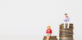 Ein Mann und eine Frau stehen auf Münzen, was ist der Gender Pay Gap?